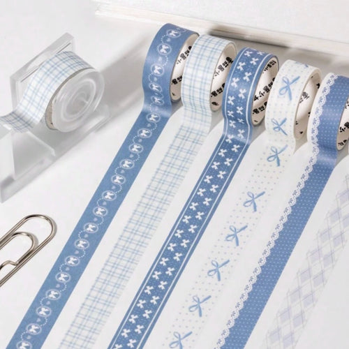 Set of blue and white washi tapes with various patterns on a white background